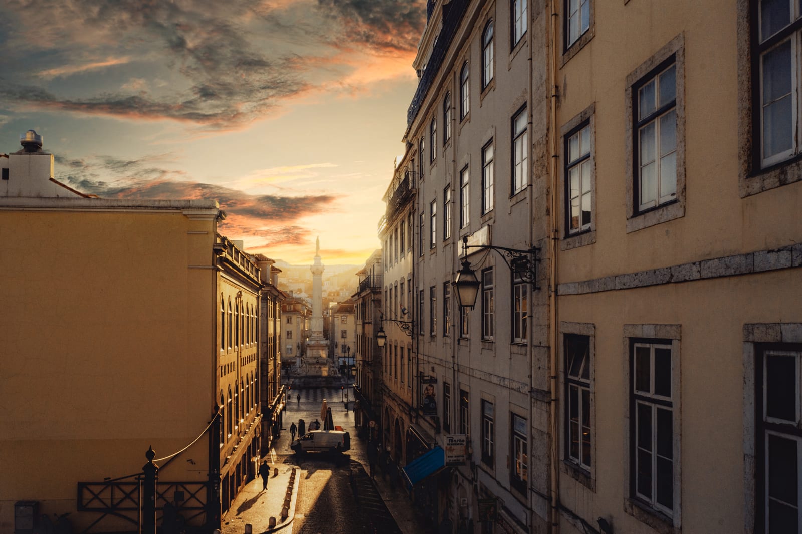 Sunset over a narrow old-town street lined with tall facades