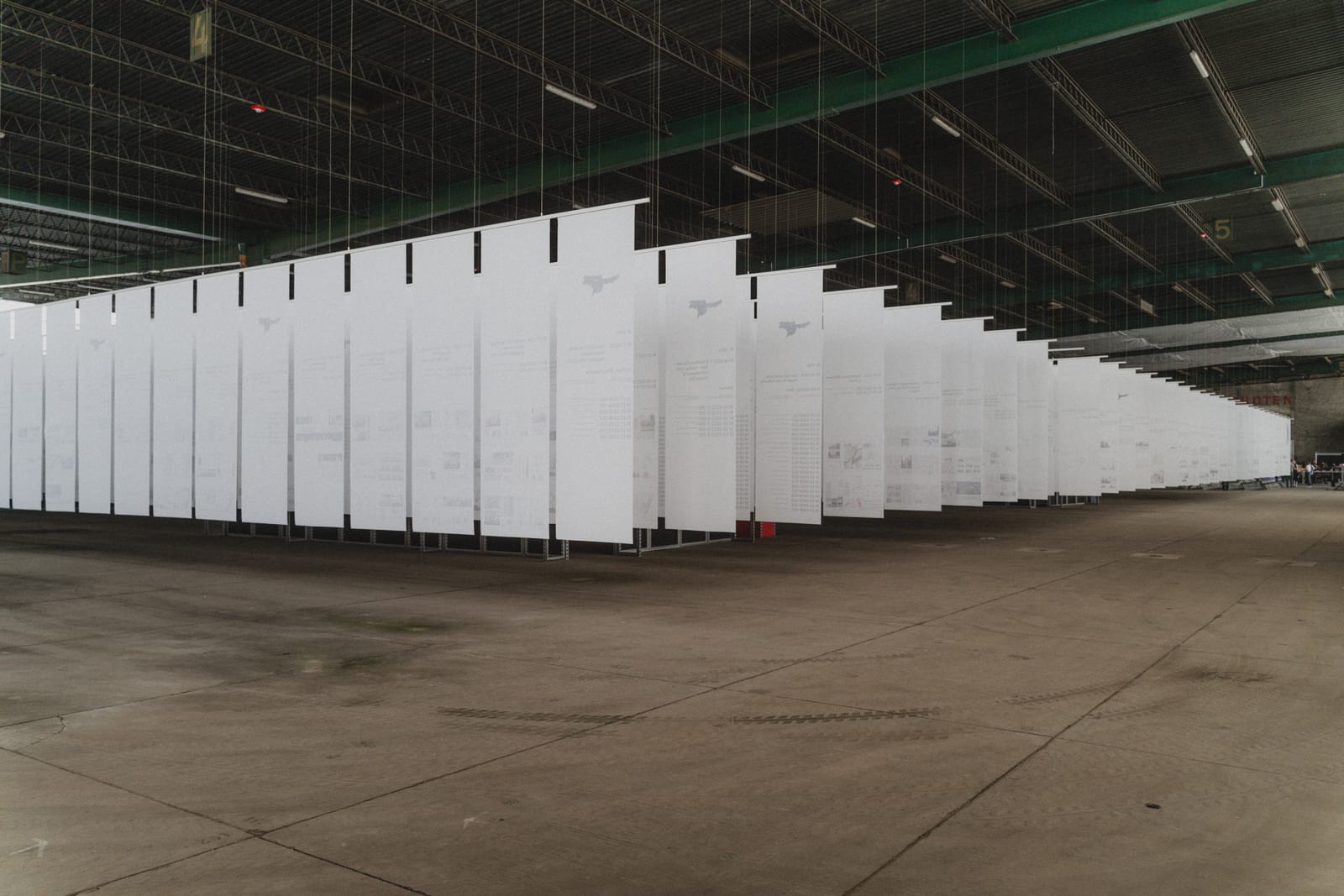 Rows of white panels hanging in an industrial hall